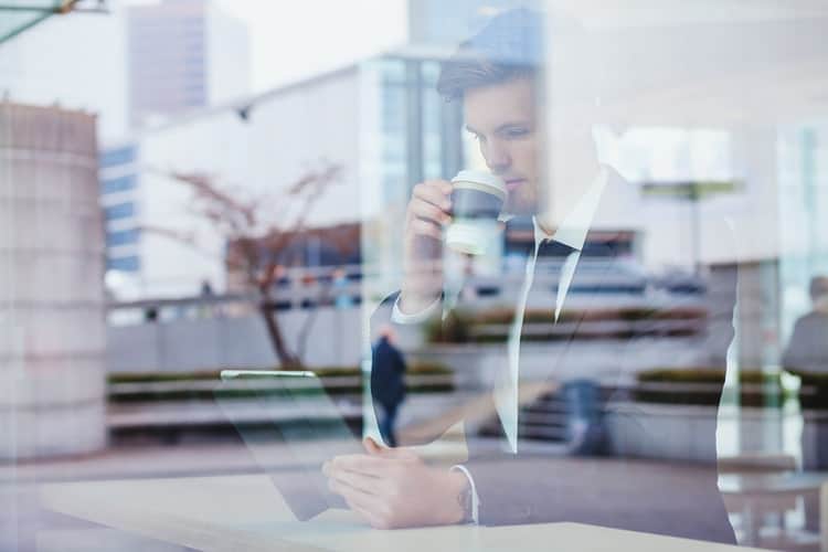 Business person reading the news on tablet