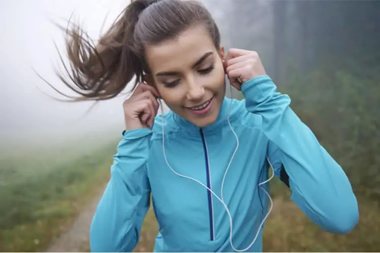 Woman exercising and using earphones