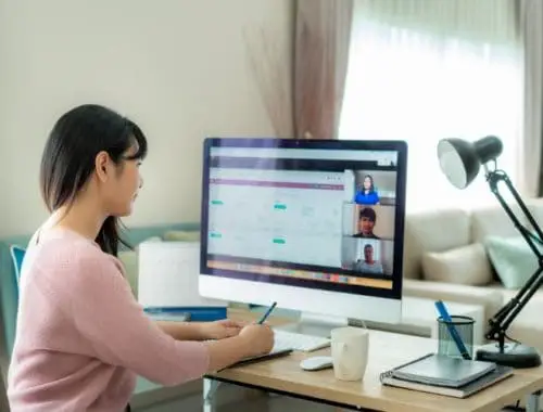 Woman remote working at home on her computer